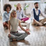 Employees meditating at the workplace