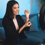 Female makeup influencer vlogging online with smartphone cam and ring led from home