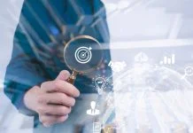 Business development businessman using Magnifier glass focus to target icon which for planning development leadership, visibility and customer target group