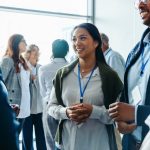 Corporate event with diverse attendees enjoying refreshments and networking